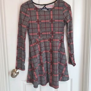 A long sleeved black and red plaid dress.